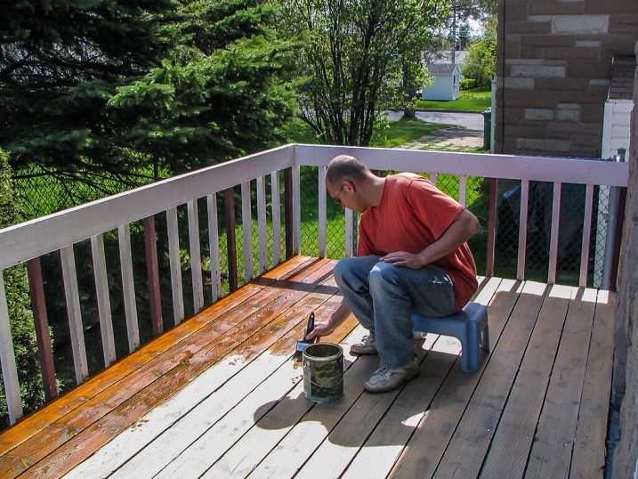Man varnishing his deck